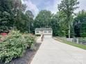Charming two-story home with a spacious driveway and well-maintained landscaping at 125 Shenandoah Loop, Troutman, NC 28166
