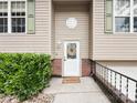 Inviting front porch featuring a decorative door and manicured bushes at 125 Shenandoah Loop, Troutman, NC 28166