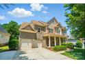 Beautiful two-story home featuring a two-car garage, charming front porch, and meticulously landscaped yard at 129 N Audubon Ave, Mooresville, NC 28117