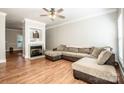 Spacious living room featuring hardwood floors, a fireplace, and a ceiling fan at 146 Valley Glen Dr, Troutman, NC 28166