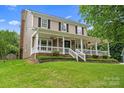 Charming two-story home with a covered front porch, landscaped yard, and beautiful curb appeal at 1543 Newfound Hollow Dr, Charlotte, NC 28214
