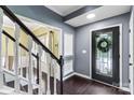Elegant foyer with hardwood floors, staircase, and a decorative glass front door at 1543 Newfound Hollow Dr, Charlotte, NC 28214