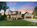 Beautiful two-story home with a landscaped yard and a detached two-car garage at 175 Mcleod Ave, Belmont, NC 28012