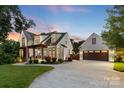 Beautiful two-story home with a landscaped yard and a detached two-car garage at 175 Mcleod Ave, Belmont, NC 28012