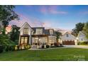 Beautiful two-story home with a landscaped yard and a detached two-car garage at 175 Mcleod Ave, Belmont, NC 28012