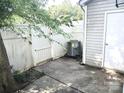 Small back patio with white picket fence and siding. Perfect for relaxing outdoors at 1911 Flushing Ct, Charlotte, NC 28215