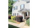 Home's entrance with well-maintained landscaping around the front entrance of the townhome at 1911 Flushing Ct, Charlotte, NC 28215