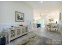 Open-concept foyer leading to the living area with a decorative cabinet and modern decor at 2004 Plain Field Dr, Bessemer City, NC 28016