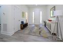 Bright foyer with light wood-look floors, white walls, and contemporary furnishings at 2004 Plain Field Dr, Bessemer City, NC 28016