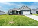 Charming one story home featuring a well maintained lawn, navy siding, and a two-car garage at 201 S 5Th Ave, Maiden, NC 28650