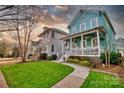 Charming blue two-story home with a welcoming front porch and sidewalk at 228 Coneflower Pl, Fort Mill, SC 29708