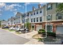 Townhouse boasts a brick and siding exterior, complemented by a driveway and verdant landscaping at 2945 Duvalla Ave, Charlotte, NC 28209