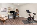 Office space offers a desk, exercise bike, wood floors, and natural light at 2945 Duvalla Ave, Charlotte, NC 28209