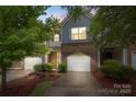 Inviting brick townhome featuring an attached garage and manicured landscaping at 3237 Yarmouth Ln, Gastonia, NC 28056