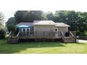 View of the back of the home with a spacious deck, perfect for outdoor entertaining and relaxation at 332 Daybrook Dr, Landis, NC 28088