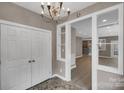 Bright entryway featuring tiled floors, a chandelier, closet and an open view into other rooms at 3333 Roberta Rd, Concord, NC 28027
