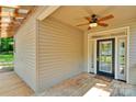 Inviting front porch with ceiling fan and a beautiful front door with glass panels at 3333 Roberta Rd, Concord, NC 28027