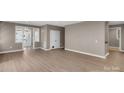 Spacious living room with a neutral color palette, white trim, and abundant natural light at 3333 Roberta Rd, Concord, NC 28027