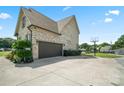 Large brick home featuring an attached two-car garage and a basketball hoop, perfect for Gathering fun at 3340 Emerald Pointe Ct, Monroe, NC 28110