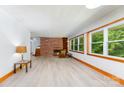 Bright living room featuring a brick fireplace, built-in shelving, and large windows at 3420 Long Ferry Rd, Salisbury, NC 28146