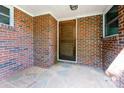 The covered patio has brick walls, flagstone flooring, and a wooden door at 3420 Long Ferry Rd, Salisbury, NC 28146