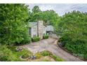 Scenic view of the home with lush greenery, a stone chimney and long driveway at 40 Old Rd, Taylorsville, NC 28681