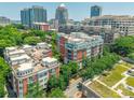 A lovely brick condominium building nestled among lush green trees with city views and a pristine rooftop at 401 N Church St # 201, Charlotte, NC 28202