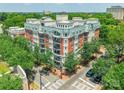 Beautiful brick condominium building with white trim, multiple balconies, mature trees, and a manicured corner lot at 401 N Church St # 201, Charlotte, NC 28202