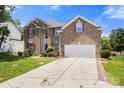 Charming brick home with a two-car garage, beautiful landscaping, and a long driveway that could accommodate extra parking at 4764 Brockton Nw Ct, Concord, NC 28027