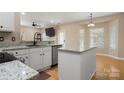 Modern kitchen with granite counters, a large island and stainless steel appliances at 4764 Brockton Nw Ct, Concord, NC 28027