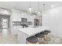Bright kitchen features quartz countertops, stainless steel appliances, pendant lighting, and a large island with seating at 492 Switch St # 82 Ty, York, SC 29745