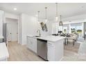 Open-concept kitchen boasts a central island, stainless steel dishwasher, and modern pendant lighting at 492 Switch St # 82 Ty, York, SC 29745