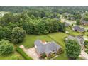 Lovely aerial view of a brick home on a generous lot with a wooden fence and patio at 5410 Berryview Ln, Gastonia, NC 28056