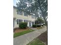 Charming townhome with blue shutters and door, complemented by neat landscaping and a welcoming sidewalk at 5623 Fetzer Nw Ave, Concord, NC 28027