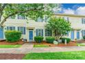Lovely townhome with a well-manicured lawn, blue shutters, and inviting front entrance at 5623 Fetzer Nw Ave, Concord, NC 28027