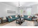 Bright living room showcasing two blue leather sofas, a decorative clock, and elegant furnishings at 5623 Fetzer Nw Ave, Concord, NC 28027