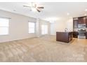Spacious living room features plush carpeting, abundant natural light, and an open layout at 709 Volta Nw Dr, Concord, NC 28027
