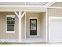 Inviting entryway featuring a black front door, white trim, and a large window for natural light at 7601 Hammond Dr, Charlotte, NC 28215