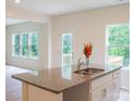 Stylish kitchen island with granite countertops, stainless steel sink, and ample cabinet space, perfect for entertaining at 7601 Hammond Dr, Charlotte, NC 28215