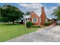 This home features a brick exterior, a manicured front yard, and a convenient ramp at 761 Milton Ave, Rock Hill, SC 29730