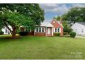 Charming brick home featuring a well-manicured lawn and a mature tree at 761 Milton Ave, Rock Hill, SC 29730