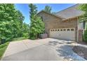 Spacious two car garage with a large concrete driveway and beautiful backyard surrounded by mature trees at 7916 Deerbridge St, Mint Hill, NC 28227