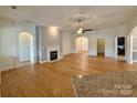 Inviting living room featuring a fireplace, hardwood floors, and an open layout to adjoining rooms at 8429 Olde Stonegate Ln, Mint Hill, NC 28227
