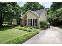 Inviting home with a well-manicured lawn and a long driveway, surrounded by lush trees at 8618 Rittenhouse Cir, Charlotte, NC 28270