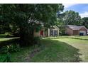 Beautiful house with lush greenery, a red front door, and a serene neighborhood setting at 8618 Rittenhouse Cir, Charlotte, NC 28270