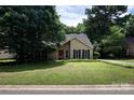 Attractive single-Gathering house with a manicured lawn and mature trees enhancing its curb appeal at 8618 Rittenhouse Cir, Charlotte, NC 28270
