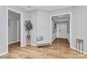 Bright and airy foyer featuring hardwood floors, neutral paint, and a welcoming bench seat at 8722 Heron Glen Dr, Charlotte, NC 28269
