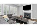 Comfortable living room with shutters, a fireplace, and hardwood floors at 8722 Heron Glen Dr, Charlotte, NC 28269