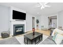 Cozy living room with fireplace, hardwood floors, and open access to the foyer at 8722 Heron Glen Dr, Charlotte, NC 28269
