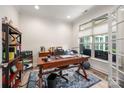Bright home office featuring hardwood floors, a large window, and stylish furnishings for a productive workspace at 1006 Gradison Dr, Matthews, NC 28104